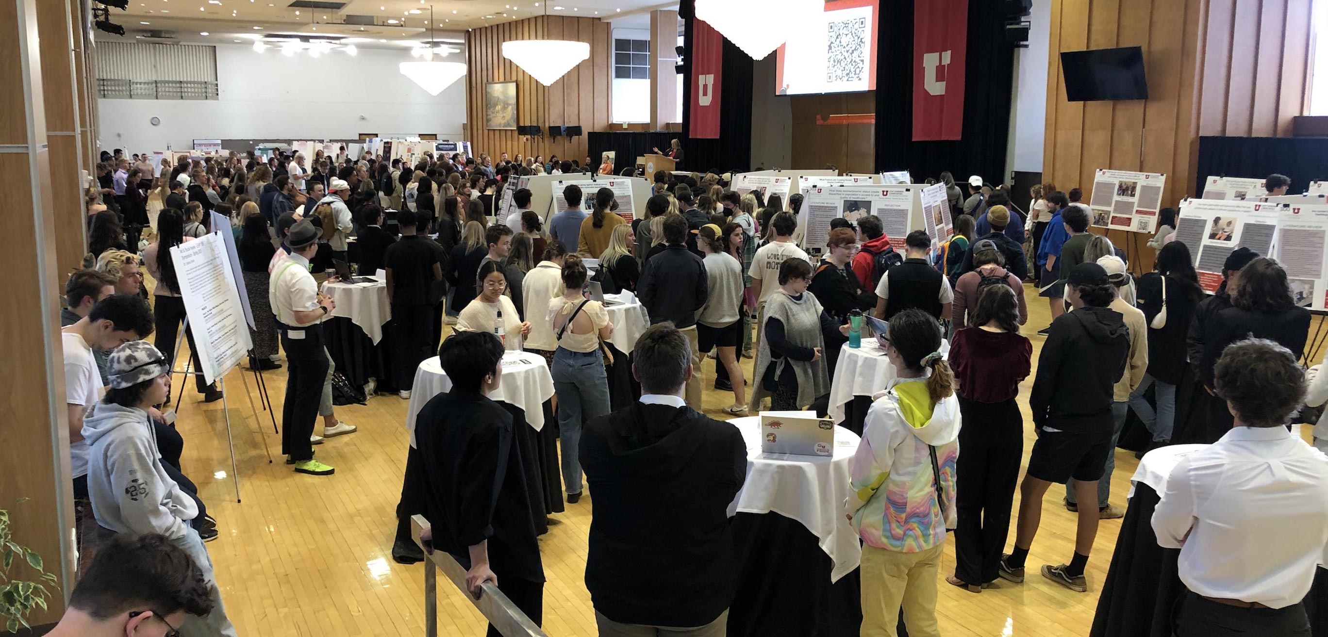 Image from the 2023 LEAP Symposium. Group of people standing in large room.